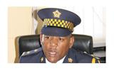 A member of Lesotho police finds a human skull in a pile of sand.